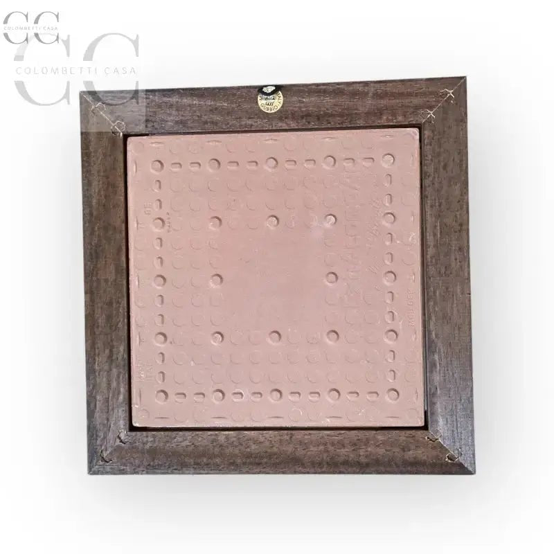 Framed pink tile with circular indentations for Mestieri il Cacciatore in Legno Tarlato