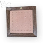 Framed pink tile with circular indentations for Mestieri il Cacciatore in Legno Tarlato